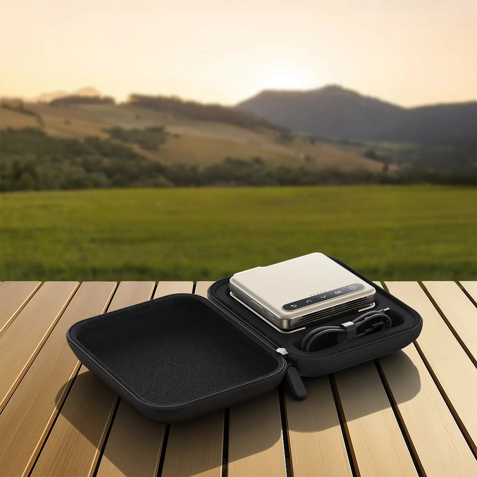Aurzen ZIP projector and cable stored in CasePlay case on outdoor table – travel-friendly setup