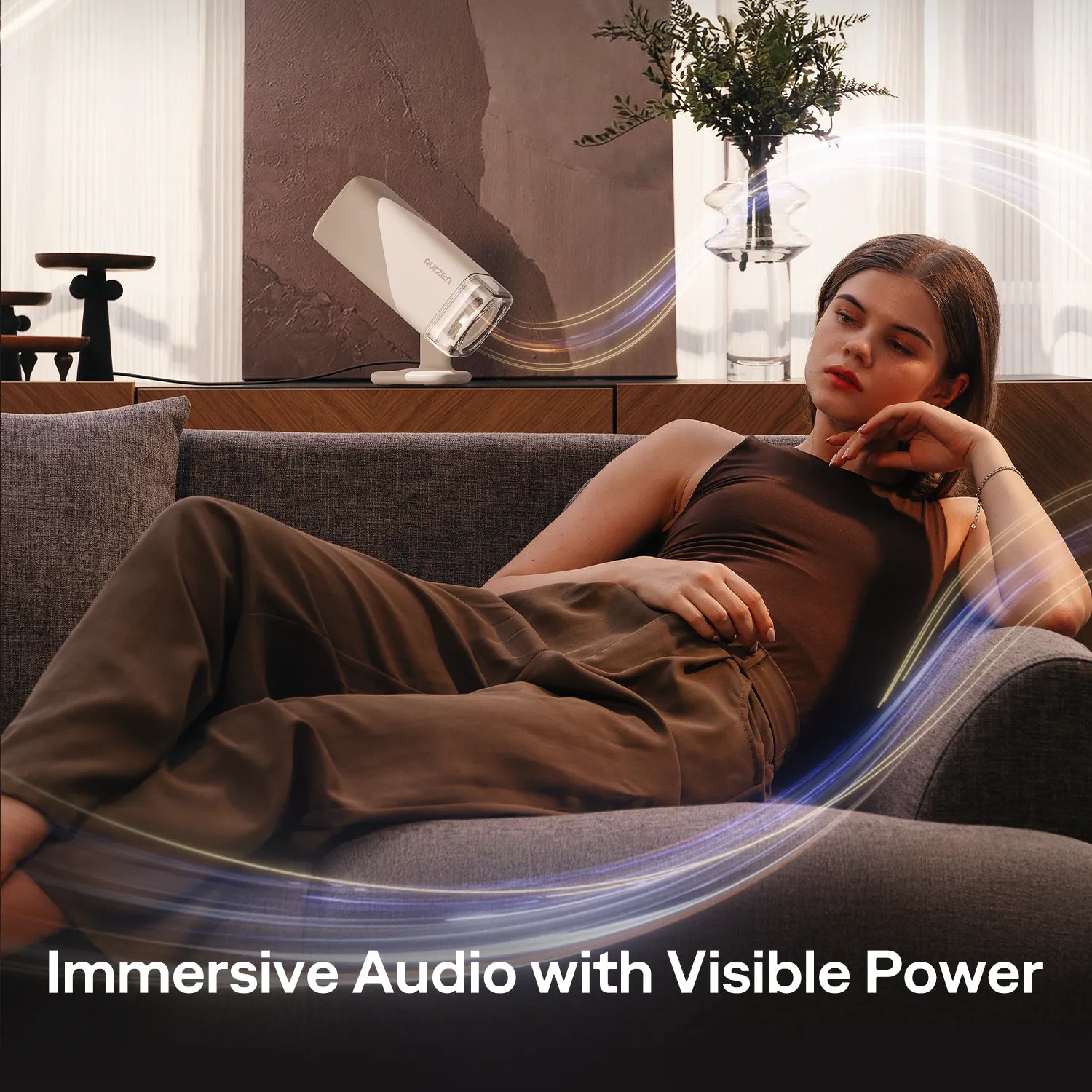 Aurzen BOOM Air projector delivering Dolby-powered immersive sound in a cozy living room setup